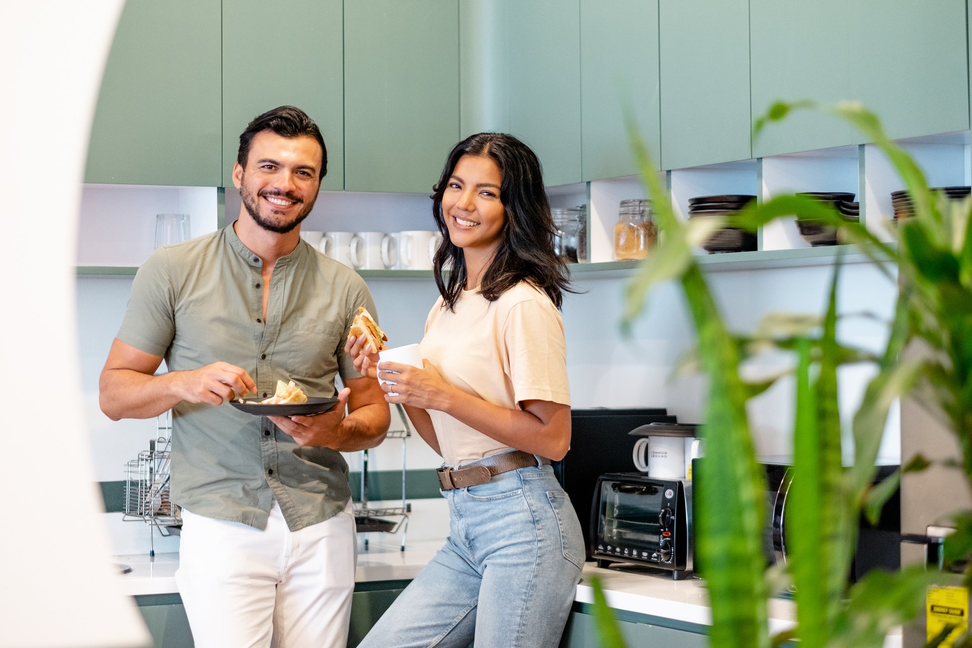 Male and Female Coworkers Eating in the Office Kitchen